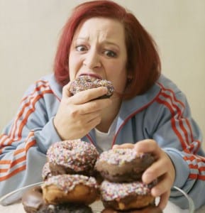 Woman Eating Stacks of Donuts